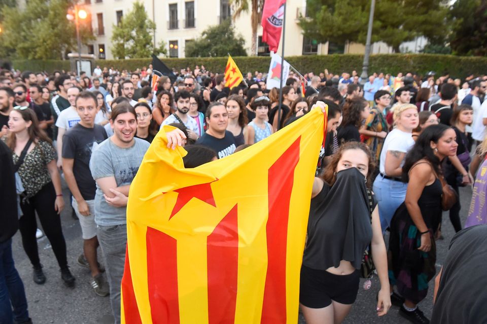 A woman holds a Catalan pro-independence 