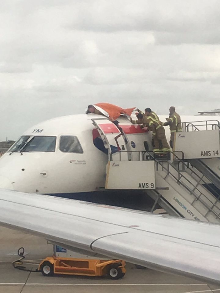 Firefighters retrieving James Brown from the roof of the aircraft. 