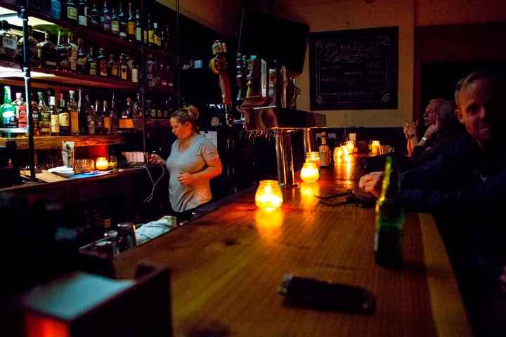 A candle-lit bar in Sonoma, California, amid a wide power outage that is expected to last several days.