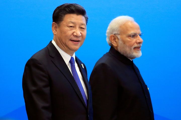 China's President Xi Jinping and India's Prime Minister Narendra Modi arrive for a signing ceremony during the Shanghai Cooperation Organization (SCO) summit in Qingdao, Shandong Province, China June 10, 2018. REUTERS/Aly Song