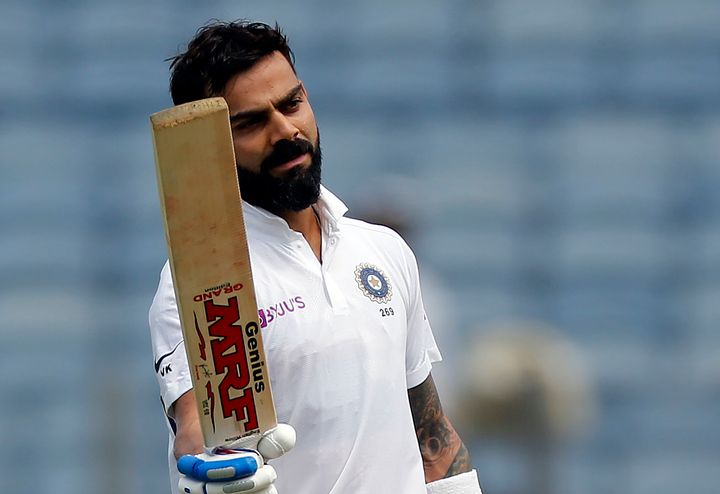 Indian cricketer Virat Kohli celebrates after scoring a century during the second day of the second cricket test match between India and South Africa in Pune on October 11, 2019.