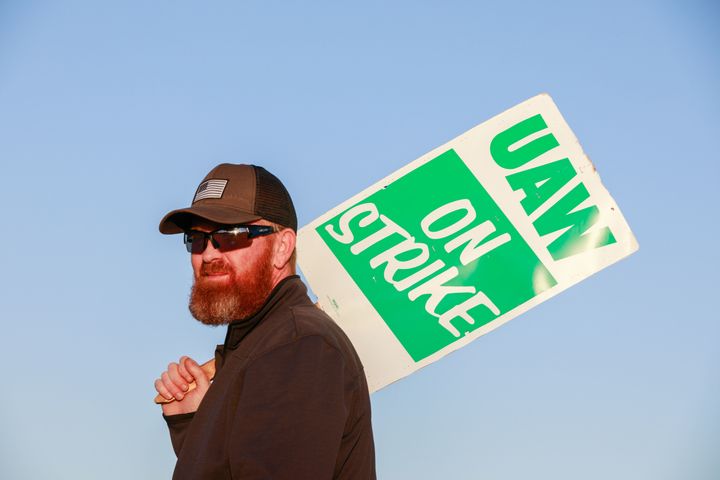 A member of UAW Local 440 on a General Motors picket line in Bedford, Indiana. The strike has cost GM an estimated $1.13 billion.