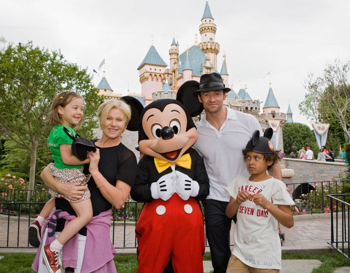 Jackman and his family pose with Mickey Mouse outside Sleeping Beauty Castle at Disneyland on April 23, 2009, in Anaheim, California.
