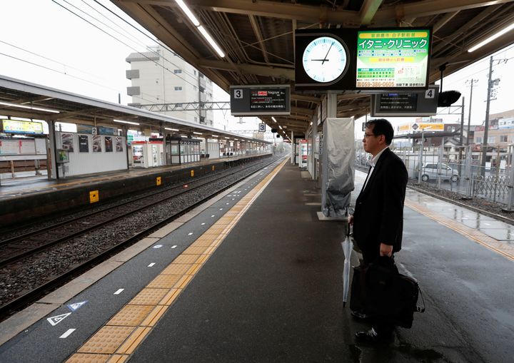 A man waits for a train at an almost empty Shiroko station, during heavy rain and winds ahead of Typhoon Hagibis, in Shiroko, Suzuka, Japan October 12, 2019. REUTERS/Soe Zeya Tun