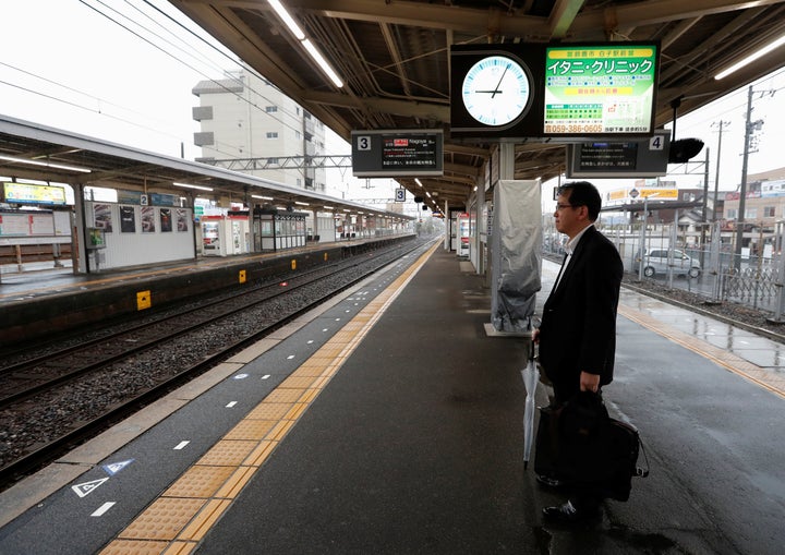 A man waits for a train at an almost empty Shiroko station, during heavy rain and winds ahead of Typhoon Hagibis, in Shiroko, Suzuka, Japan October 12, 2019. REUTERS/Soe Zeya Tun