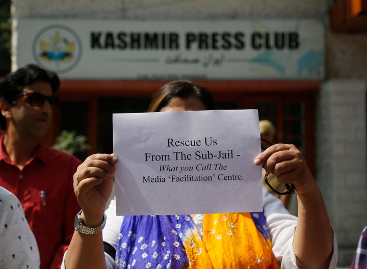 A Kashmiri journalists displays a placard during a protest against the communication blackout in Srinagar, Indian controlled Kashmir, Thursday, Oct. 3, 2019. For the last two months, mobile phones and internet services have been shut down in the valley after New Delhi stripped Indian-controlled Kashmir of its semi-autonomous powers and implemented a strict clampdown, snapping communications networks, landlines and mobile Internet. (AP Photo/Mukhtar Khan)
