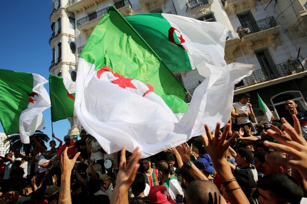 Demonstrators wave national flags during a protest against the country's ruling elite and rejecting the...