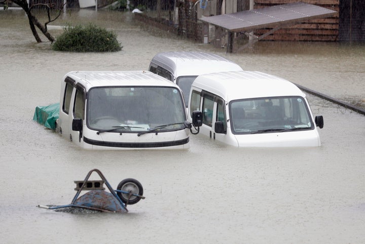 Cars sit submerged in water in the residential area hit by Typhoon Hagibis, in Ise, central Japan Saturday, Oct. 12, 2019. A 