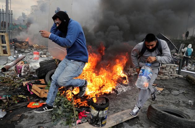 Demonstrators run during a protest against Ecuador's President Lenin Moreno's austerity measures in Quito, Ecuador October 12.