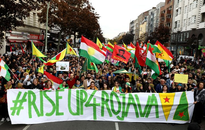 Kurdish protesters in Berlin, Germany, carry a banner during a demonstration on Oct. 12 against Turkey's military action in northeastern Syria.