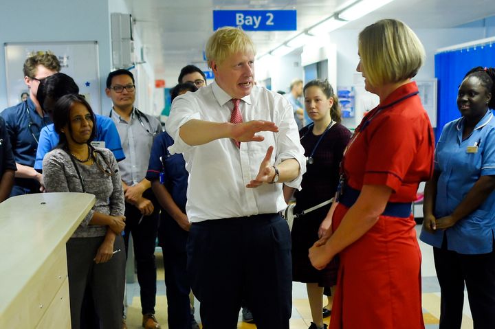 Johnson speaks to medical staff during his visit to Watford General Hospital