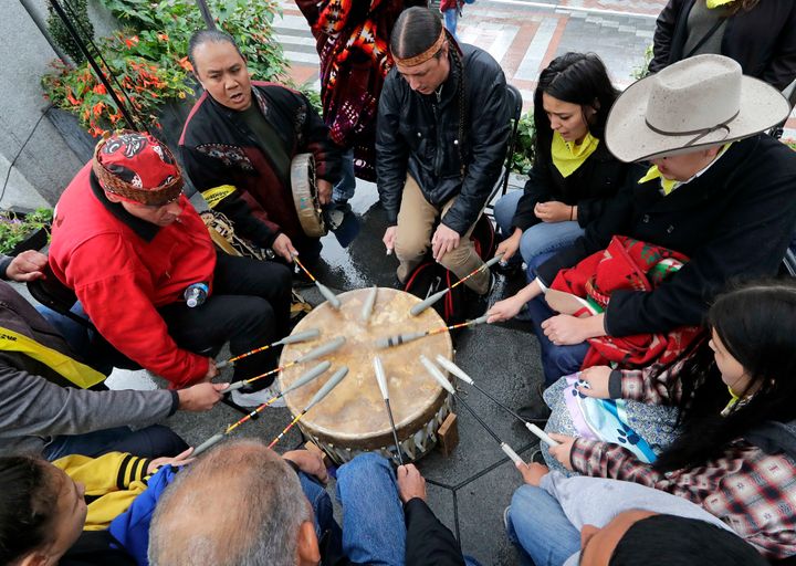Native Americans and First Nations people join in on a drum circle during an Indigenous Peoples Day blessing and rally before a march Monday, Oct. 8, 2018, in Seattle. In 2014, the Seattle City Council voted to stop recognizing Columbus Day and instead turned the second Monday in October into a day of recognition of Native American cultures and peoples. (AP Photo/Elaine Thompson)