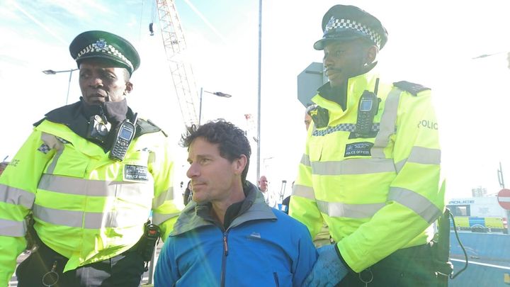 John Curran being arrested at London City Airport.