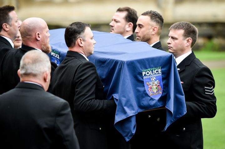 Pallbearers carry the coffin of PC Andrew Harper.