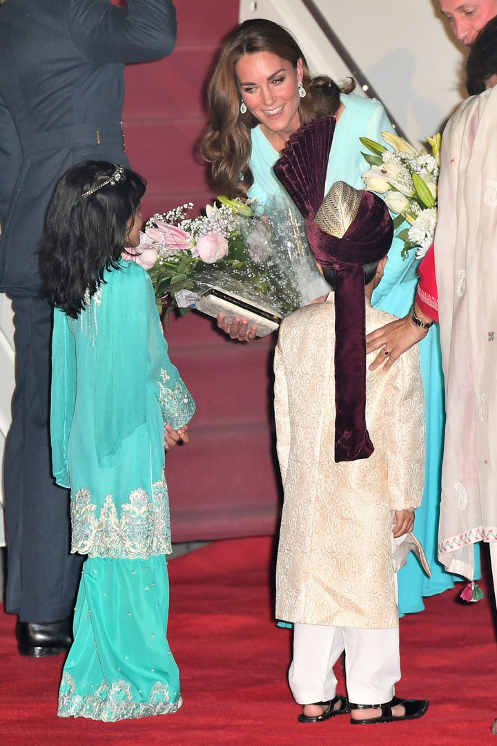 After deplaning, the Duchess of Cambridge received flowers.