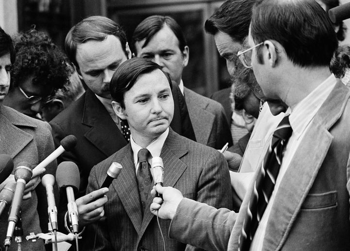 Donald Segretti, a political saboteur financed with Nixon campaign funds, is surrounded by newsmen as he listens to questions outside the U.S. District court in Washington, Oct. 2, 1973, after pleading guilty to three charges of violating federal election laws during the 1972 Democratic presidential primary in Florida. (AP Photo)