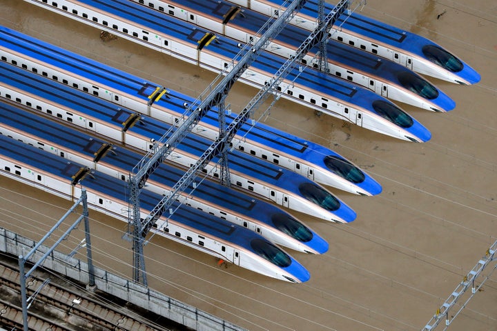 Bullet trains are seen submerged in muddy waters in Nagano, central Japan, after Typhoon Hagibis hit the city Sunday.