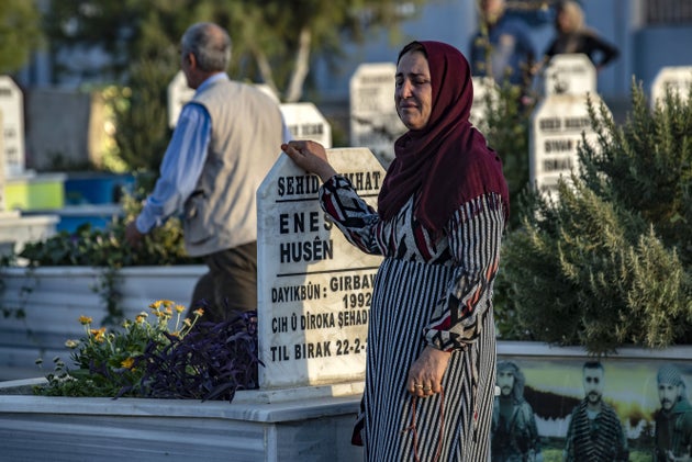 Ενώ οι εξελίξεις τρέχουν, ο πόλεμος μαίνεται και οι συμμαχίες αλλάζουν μια γυναίκα θρηνεί σε νεκτροταφείο στο Ρας αλ Αϊν. 