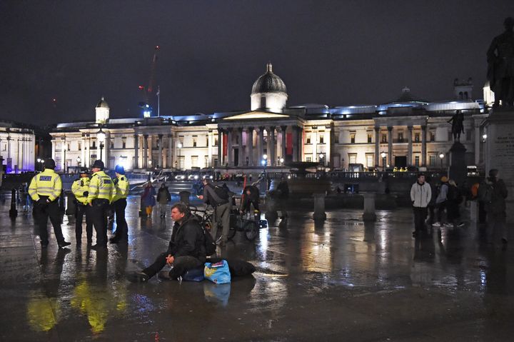 Police work to remove Extinction Rebellion protesters in Trafalgar Square, central London last night.