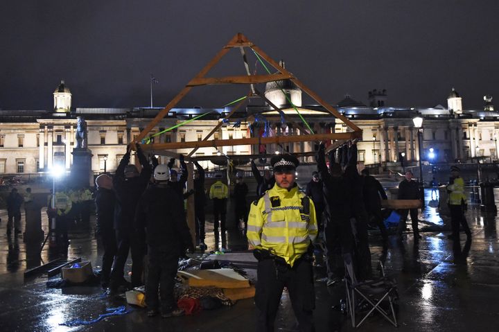 Police remove an Extinction Rebellion structure from Trafalgar Square, central London. 