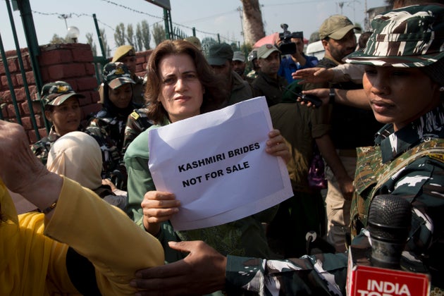 Safiya Abdullah, daughter of Farooq Abdullah, holds a placard during a protest in Srinagar on October...