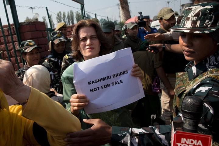 Safiya Abdullah, daughter of Farooq Abdullah, holds a placard during a protest in Srinagar on October 15, 2019.