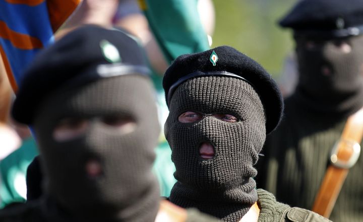 Masked members of the Real Irish Republican Army (RIRA) splinter group parade during a 1916 Easter Rising commemoration at Cregan Cemetery in Londonderry in 2011.