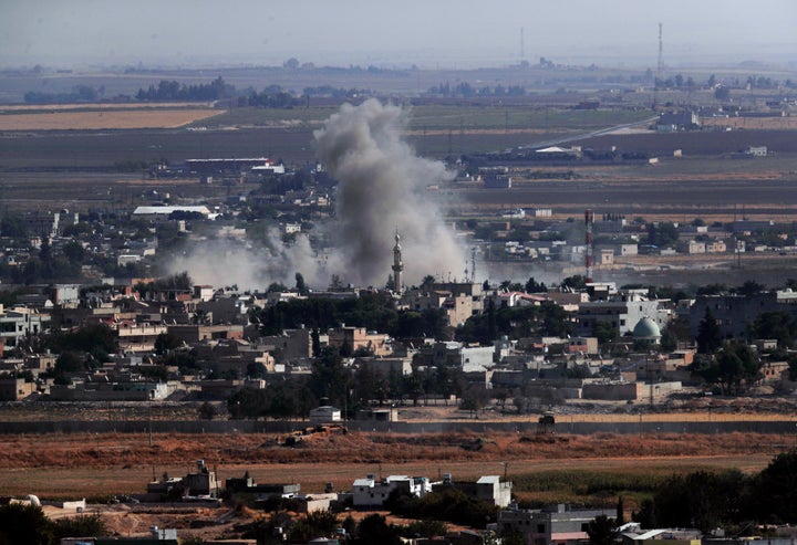 In this photo taken from the Turkish side of the border between Turkey and Syria, in Ceylanpinar, Sanliurfa province, southeastern Turkey, smoke and dust billows from targets in Ras al-Ayn, Syria, caused by bombardment by Turkish forces, Tuesday, Oct. 15, 2019