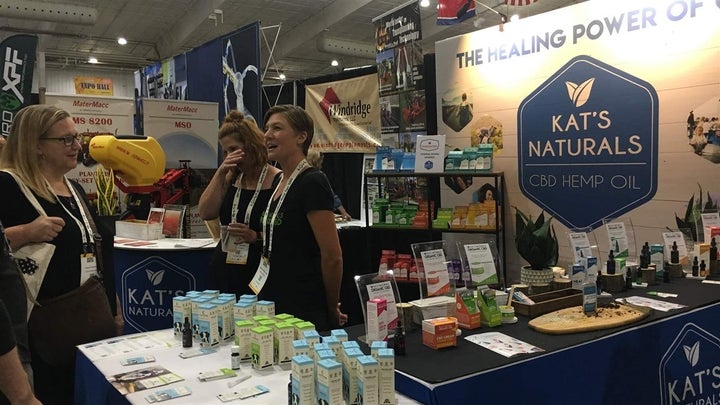 Kat Merryfield, right, answers questions about her organic hemp business, Kat’s Naturals, at the Southern Hemp Expo in Franklin, Tennessee, last month. Merryfield has struggled to find a reliable payment processor because of confusion among banks and credit unions on how to serve hemp businesses while federal regulations are up in the air.