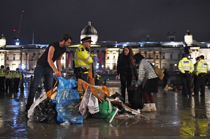 Protesters gather their belongings as police work to remove the last of the Extinction Rebellion demonstration in Trafalgar Square, central London.