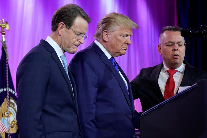 U.S. President Donald Trump prays between Tony Perkins, president of the Family Research Council, and Pastor Andrew Brunson (right) at the Family Research Council's annual gala in Washington, U.S., Oct. 12, 2019.
