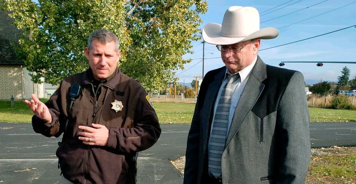 Lewis and Clark County Undersheriff Jason Grimmis, left, and Sheriff Leo Dutton, right, update reporters on a homemade bomb that detonated in an elementary school playground on Tuesday, Oct. 15, 2019, in Helena, Mont.