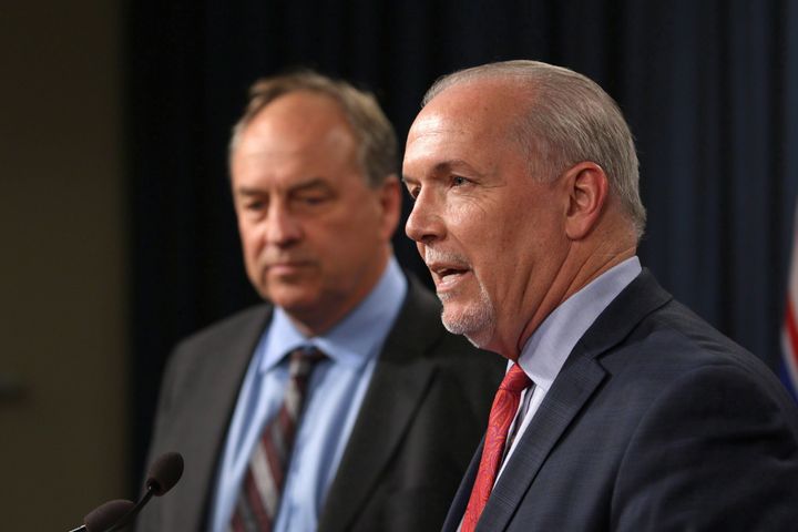 B.C. Premier John Horgan and B.C. Green Party Leader Andrew Weaver speak to media following a 2017 announcement banning union and corporate donations to political parties. 