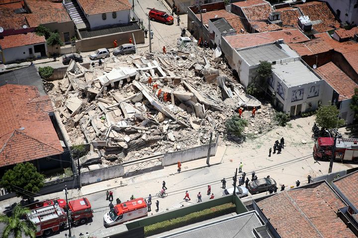 Firefighters search for survivors after a building collapsed in Fortaleza, Ceara state, Brazil, Tuesday, Oct. 15, 2019. A seven-story building collapsed Tuesday in an upscale part of the Brazilian city of Fortaleza, killing one person and leaving others trapped with some communicating with family members by cellphone from under debris, officials said. (Jose Leomar/Diario do Nordeste via AP)