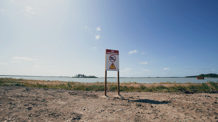 A "No Swimming" sign is shown on the Tataskweyak Cree Nation on Aug. 21, 2019.