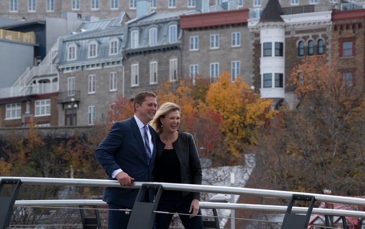Conservative Leader Andrew Scheer and his wife Jill Scheer walk across a bridge following a campaign stop in Quebec City on Oct 15, 2019.