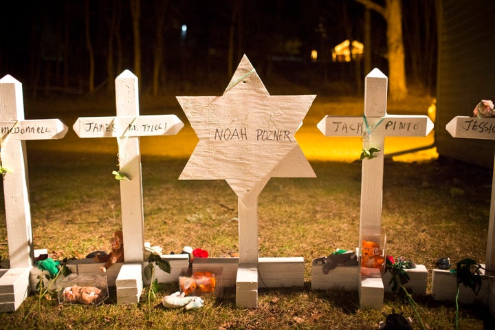 A Star of David for Noah Pozner is seen amongst 25 crosses at a memorial for those killed in the massacre at Sandy Hook Elementary School.