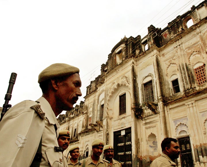 A policeman stands guard outside a temple in Ayodhya, July 6, 2005.