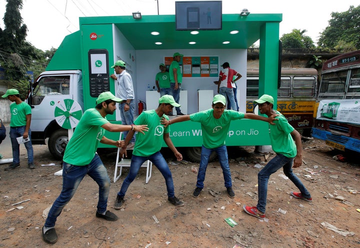 WhatsApp-Reliance Jio representatives perform in a street play during a drive by the two companies to educate users, on the outskirts of Kolkata, India.