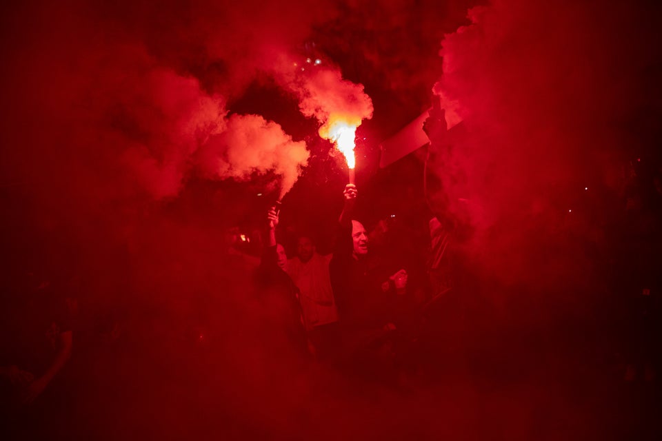 Right wing pro-Spanish unity supporters light flares during a demonstration in Barcelona, Spain, Thursday, Oct. 17, 2019. Catalonia's separatist leader vowed Thursday to hold a new vote to secede from Spain in less than two years as the embattled northeastern region grapples with a wave of violence that has tarnished a movement proud of its peaceful activism. (AP Photo/Bernat Armangue)