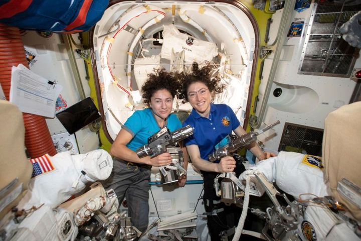 In this photo released by NASA on Thursday, Oct. 17, 2019, U.S. astronauts Jessica Meir, left, and Christina Koch pose for a photo in the International Space Station. On Friday, Oct. 18, 2019, the two are scheduled to perform a spacewalk to replace a broken battery charger. (NASA via AP)