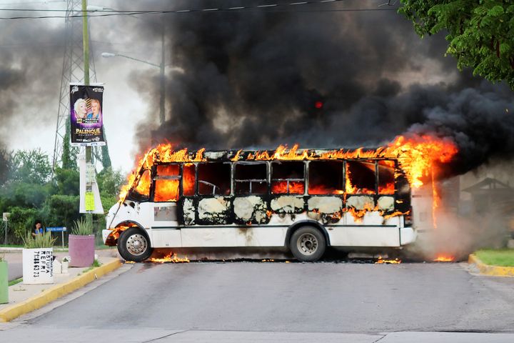 A burning bus, set alight by cartel gunmen to block a road, is pictured during clashes with federal forces following the detention of Ovidio Guzman, son of drug kingpin Joaquin "El Chapo" Guzman.