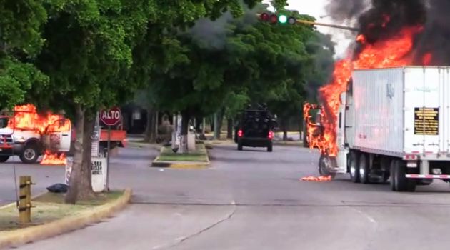 In this AFPTV screen trucks burn in a street of Culiacan, capital of jailed kingpin Joaquin 