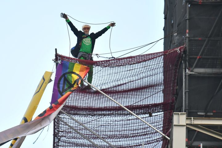 An Extinction Rebellion protester who has scaled the scaffolding surrounding Big Ben at the Houses of Parliament, Westminster, London.