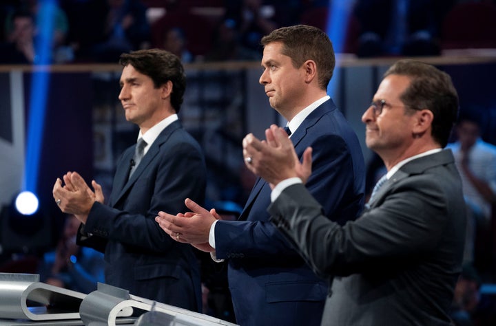 Liberal Leader Justin Trudeau, Conservative Leader Andrew Scheer and Bloc Québécois Leader Yves-Francois Blanchet applaud as they take part in the federal leaders' French-language debate in Gatineau, Que. on Oct. 10, 2019. 