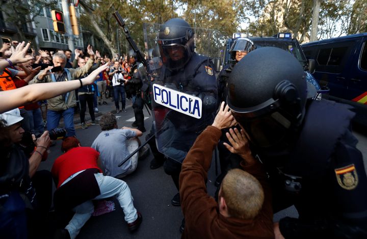 Riot police try to remove Catalan demonstrators during a protest in central Barcelona, Spain, October 19, 2019..