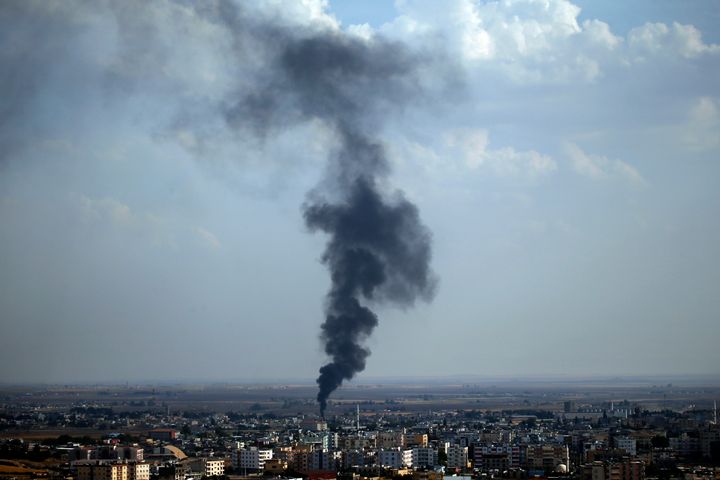 In this photo taken from the Turkish side of the border between Turkey and Syria, in Ceylanpinar, Sanliurfa province, southeastern Turkey, smoke billows from a fire in Ras al-Ayn, Syria, Friday, Oct. 18, 2019.