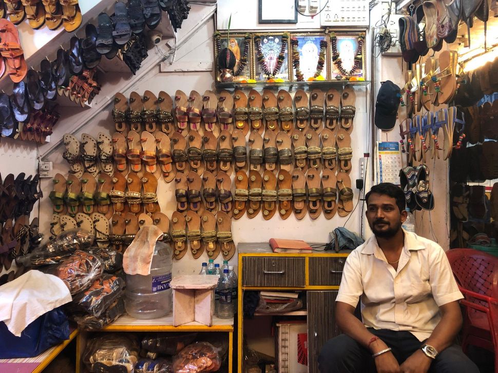 Dattatray Arale at the ‘New Utsav’ footwear shop in Kolhapur's Shivaji Market. "Entire business has been hit due to floods this year" and business may be down by half as compared to the last year," he said. 