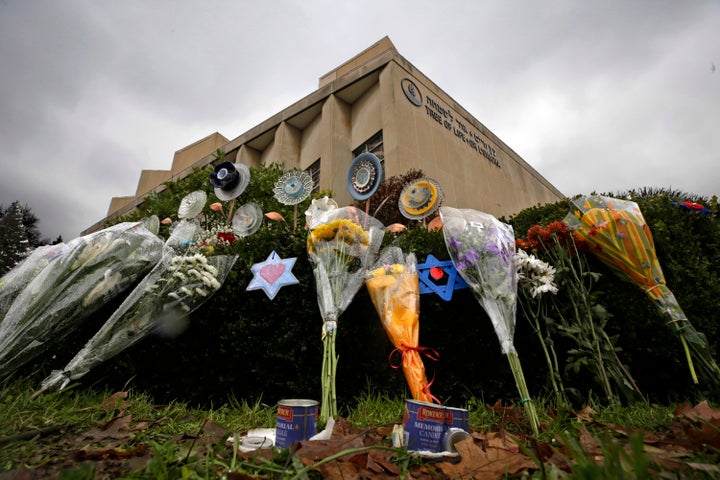 In this Nov. 20, 2018, file photo, a makeshift memorial of flowers rests on bushes outside the Tree of Life Synagogue in Pitt