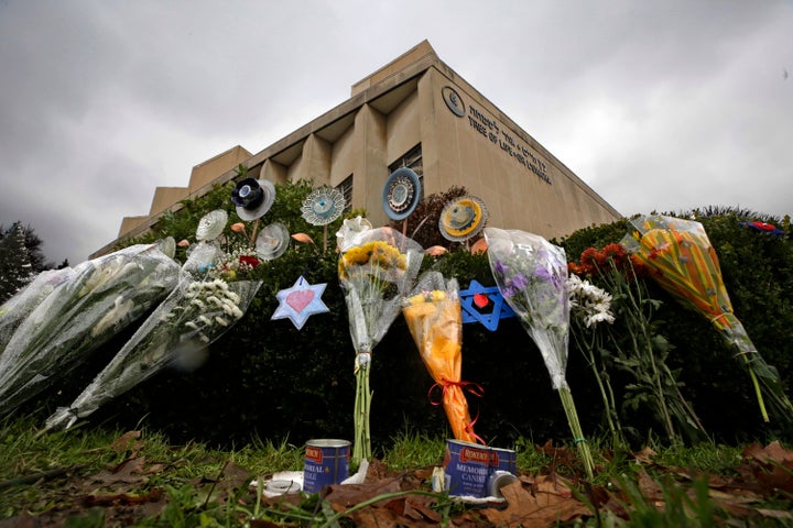 In this Nov. 20, 2018, file photo, a makeshift memorial of flowers rests on bushes outside the Tree of Life Synagogue in Pittsburgh.